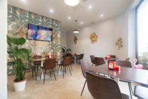 a dining room with tables and chairs and a plant at Montecristo B&B in Grosseto