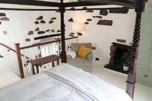 a bedroom with a bed and a fireplace at Bluebell cottage in Ulverston