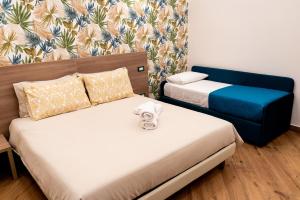 a room with two beds and a blue chair at Foria 143 in Naples