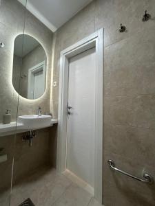a bathroom with a shower and a sink and a mirror at Villa Marina in Dobra Voda