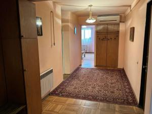 an empty hallway with a rug on the floor and a door at Apartments on Sarmen in Yerevan +14 photos
