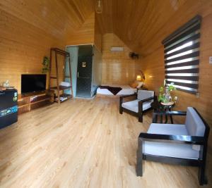 a large living room with wooden walls and wooden floors at Phoenix Hotel Pool Villa in Hoi An