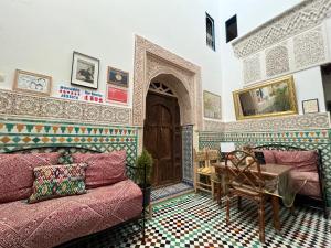 a living room with a couch and a table at Dar Sunrise Fes in Fez