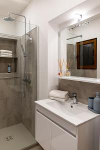 a bathroom with a sink and a shower at Oliver street apartment Vipava in Vipava