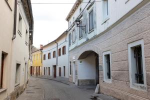 an alley in an old town with white buildings at Oliver street apartment Vipava in Vipava