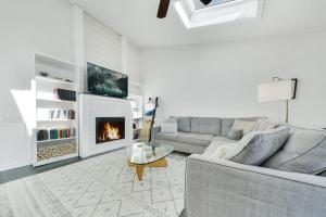 a living room with a couch and a fireplace at NEW Urban Comfort On Grant St in Lake Geneva