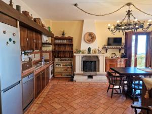 uma cozinha com uma mesa e uma lareira em VILLA PANORAMICA DELL'ETNA em SantʼAlfio