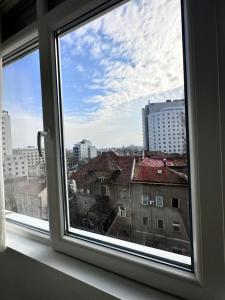a window with a view of a city at Love Light Studio Victoriei in Bucharest