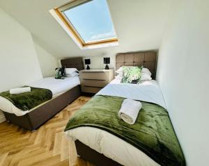 a bedroom with two beds and a window at Social Central - No 1 for large groups in Cardiff