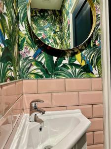 a bathroom with a sink and a mirror at Social Central - No 1 for large groups in Cardiff +58 photos