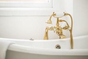 a bathroom sink with a gold faucet at Large 2 story penthouse apartment, impressive views in Bristol