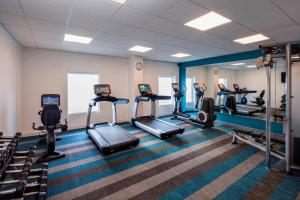 a gym with treadmills and ellipticals in a room at Aloft Miami Dadeland in Kendall