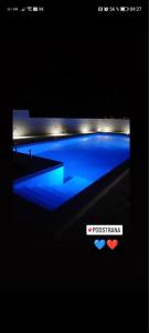 um ecrã de televisão com uma piscina no escuro em Villa Ana perfect for families with kids and groups,House with heated Pool em Podstrana