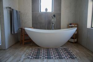 a white bath tub in a bathroom with a window at 137 Vaal De Grace Golf Estate in Parys