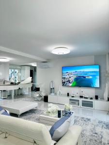 a living room with a large tv on the wall at Maison lumineuse à Torcy in Torcy