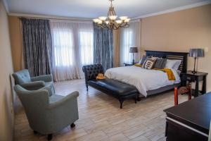 a bedroom with a bed and a chair at 137 Vaal De Grace Golf Estate in Parys