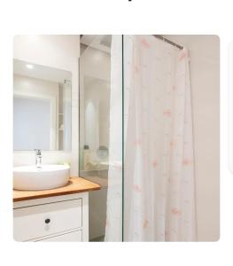 a bathroom with a sink and a shower curtain at Oasis de Valencia in Valencia