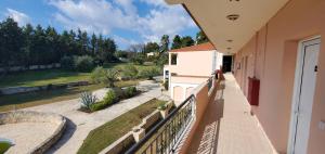 a balcony with a view of a yard at Hotel Paradise in Kriopigi