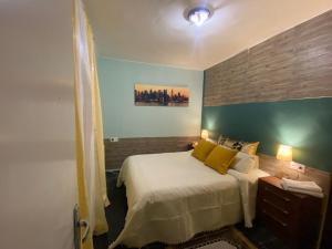 a bedroom with a bed with yellow pillows at LA CASA DE LAS HADAS in La Reguda