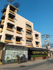 a building with a motorcycle parked in front of it at Pauna Inn Pattaya in Pattaya South