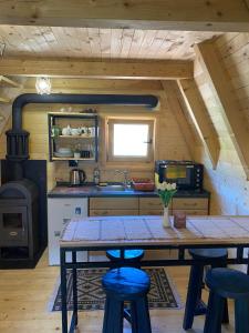 a kitchen with a table and some chairs and a stove at Nice cabin in Cetinje