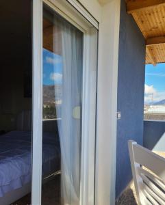 a room with a window with a bed and a view at Villa Elear in Korçë