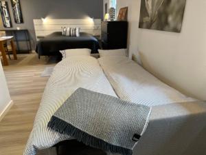a large bed in a room with a piano at Guesthouse centrally in Vetlanda in Vetlanda