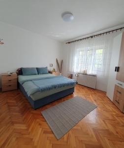 Ferienhaus Brice / Mostar في موستار: غرفة نوم بسرير وارضية خشبية