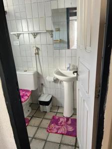 a small bathroom with a sink and a toilet at Village Gales Prive Maragogi in Maragogi