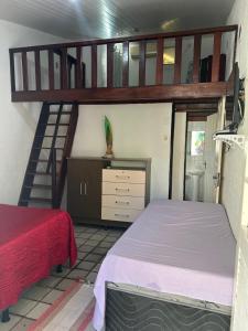 a bedroom with a bunk bed and a staircase at Village Gales Prive Maragogi in Maragogi