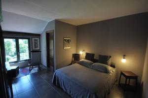 a bedroom with a bed and a large window at beppe country house in Asti