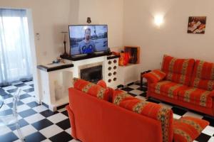 a living room with two couches and a television at Playa del Sol-Casa Playa in Denia