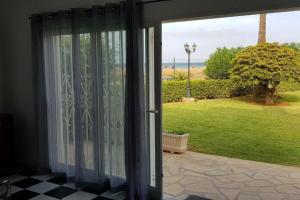 an open sliding glass door with a view of a yard at Playa del Sol-Casa Playa in Denia
