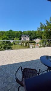 a patio with a table and chairs and a fence at GRANDIAL in Władysławowo