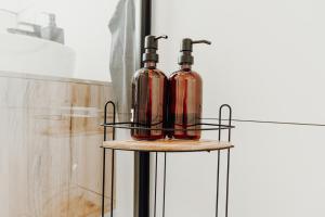 two glass bottles sitting on top of a stand at WohnungTraveller Geislautern in Völklingen