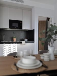 a kitchen with a table with white plates on it at Tembo Barcelona in Barcelona