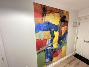 a painting on a wall in a room at Casa Crusoe - Part of the The Bay Filey Holiday Village with pool, gym and direct beach access, pub, restaurant, tennis and meadows walks in Reighton