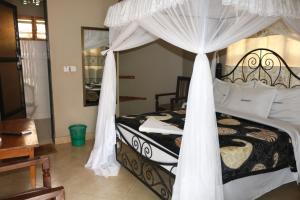 a bedroom with a bed with a canopy at POAPARK RESORT 