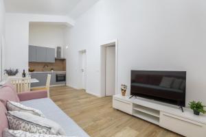a living room with a large flat screen tv at Sea La Vie in Fažana