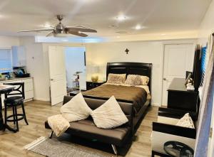 a bedroom with a bed and a couch and a kitchen at Serenity home in Laplace +23 photos