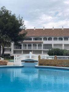 a large building with a bridge over a swimming pool at Al_andalus_404 in Alcossebre