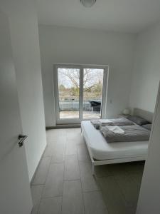 a bedroom with a bed and a large window at Guestroom Hannover Messe in Hannover