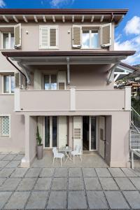 a house with two chairs and a table on a patio at Villa "LE GILDA" 5 STELLE in Massa