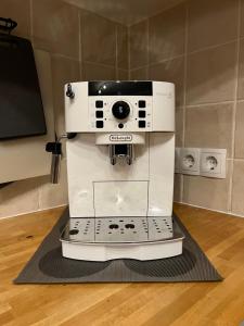 a white coffee machine sitting on top of a floor at Haus Karner in Neusiedl am See