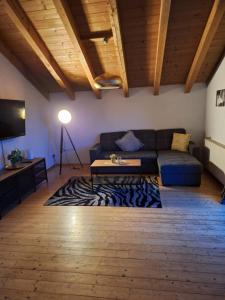 a living room with a couch and a table at Lechapart Wagner in Reutte