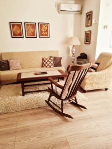 a living room with a couch and a table and a chair at CityS in Apatin