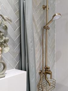 a shower with a brass lamp in a bathroom at Mere Apartment - Private Yard, Sauna and Pet Friendly in Pärnu