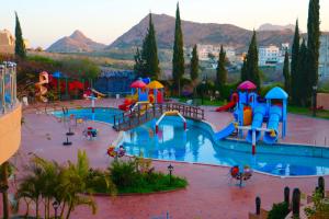 a playground with a water park with a slide at شاليهات نوفا اندلسية لبيوت العطلات in Al Hada