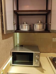 a kitchen with two pots on top of a microwave at شقق اطلالة أبحر للشقق المخدومة in Jeddah