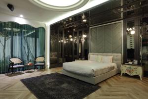 a bedroom with a large bed in a room with black walls at Mulan Motel Taipei in Taipei